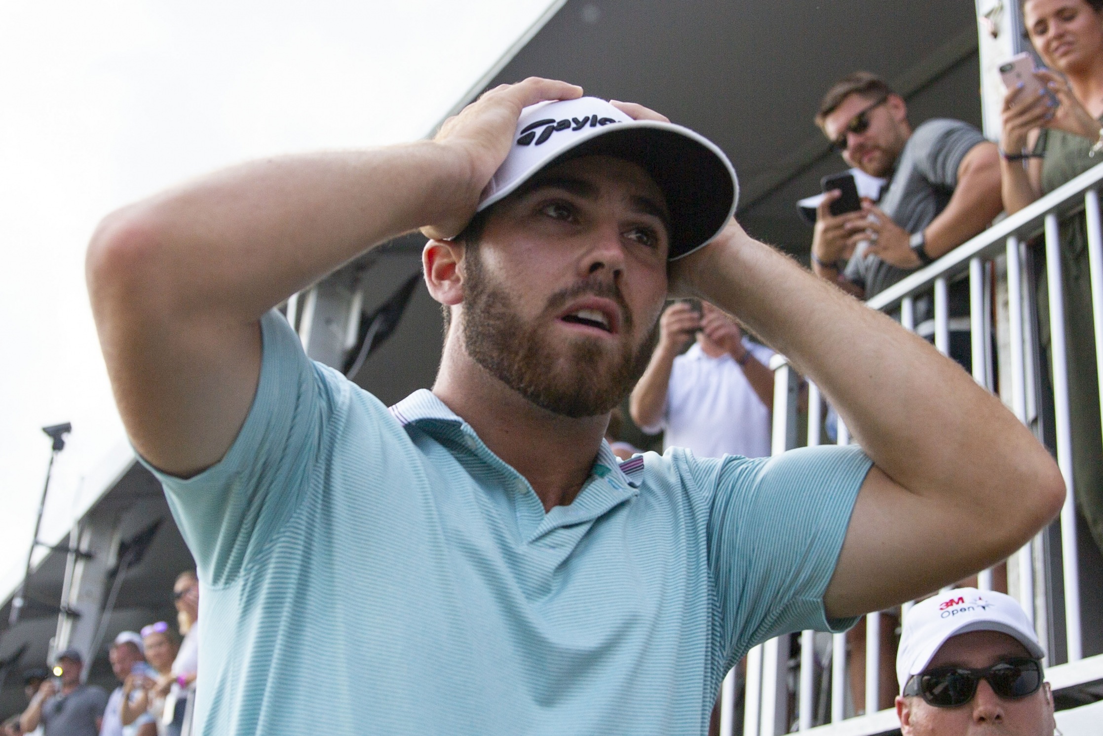 Matthew Wolff holds his head and walks off the course in disbelief after hitting an eagle to win the 3M Open. (Image: Star Tribune)