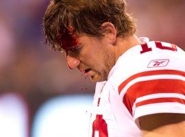 NY Giants Eli Manning walks to the sideline after receiving a gash to the head during a preseason game against the NY Jets in 2010. (Image: Damian Strohmeyer/SI)
