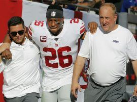 New York Giants medical staff assist Saquon Barkley to the locker room after he injured his ankle against the Tampa Bay Bucs in Week 3. (Image: Mark LoMoglio/AP)