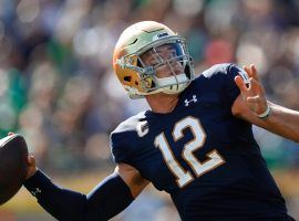 Notre Dame quarterback Ian Book will have to have a big day if the Fighting Irish is going to defeat Georgia in one of three college football teams featuring ranked squads. (Image: AP)