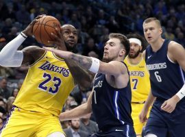 Dallas Mavericks swingman Luka Doncic defends LA Lakers forward LeBron James in an overtime loss in Dallas. (Image: Tony Gutierrez/AP)