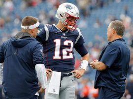 The New England Patriots brain trust with offensive coordinator Josh McDaniel (left), QB Tom Brady, and head coach Bill Belichick (right) chatting before a game at Foxboro. (Image: Getty)