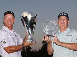 Scott McCarron, left, holds the Charles Schwab Cup that he won because Jeff Maggert won the season-ending event by holing out on the third extra playoff hole. (Image: Getty)