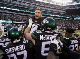 NY Jets lineman celebrate their victory over the Miami Dolphins by hoisting kicker Sam Ficken after he connected on a game-winning field goal. (Image: Adam Hunger/AP)