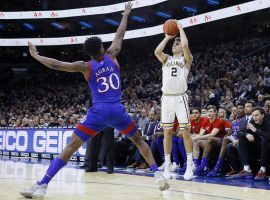 Villanova guard Collin Gillespie shoots a three-pointer against Kansas defender Ochai Agbaji in Philadelphia, PA. (Image: Matt Slocum/AP)