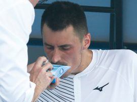 Bernard Tomic receives attention for breathing issues due to the low air quality at the Australian Open on Tuesday. (Image: Daniel Pockett/Getty)