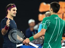 Novak Djokovic (right) defeated an injured Roger Federer (left) to reach the Australian Open final for the eighth time. (Image: Getty)