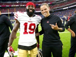 Katie Sowers, picture s 
with former 49ers reciever Aldrick Robonson, will become the first woman and openly gay Super Bowl coach. (Image: Michael Zagaris/Getty)