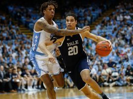 Yale forward Paul Atkinson drives to the basket against North Carolina guard Leaky Black at Chapel Hill, NC. (Image: Nell Redmond/USA Today Sports)