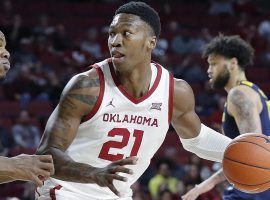 Oklahoma forward Kristian Doolittle is defended by West Virginia during a game in Norman, OK. (Image: Ty Russell/Oklahoma Athletics)