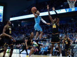 Rhode Island guard, Fatts Russell, soars to the basketball against VCU at Ryan Center in Kingston, RI. (Image: Ryan Bowman/AP)