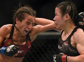 Zhang Weili (right) outpointed Joanna Jedrzejczyk (left) to defend her strawweight title in what is being hailed as one of the greatest women’s MMA fights of all time. (Image: AFP)