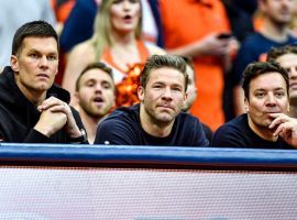 Free agent Tom Brady, left, Julian Edelman and Jimmy Fallon watch from the sidelines during the first half of an NCAA college basketball game between Syracuse and North Carolina on Saturday. (Image: AP)