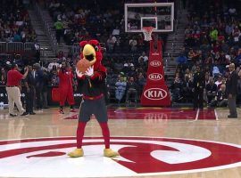The Atlanta Hawks mascot attempts a backward half-court shot during halftime at Phillips Arena. (Image: Atlanta Hawks/YouTube)