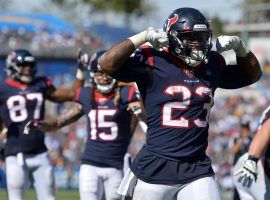 Running back Carlos Hyde flexes after scoring a touchdown for the Houston Texans last season. (Image: Jake Roth/USA Today Sports)