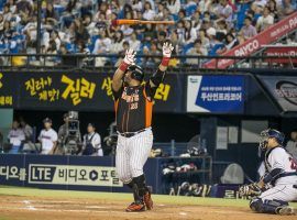 Choi Jun-seok, power hitter for the Lotte Giants, flips his bat after a home run in a 2015 KBO game. (Image: Jean Chung/New York Times)