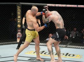 Glover Teixeira (left) punches Anthony Smith (right) during their bout at UFC Fight Night in Jacksonville on May 13, 2020. (Image: Cooper Neill/Zuffa/Getty)