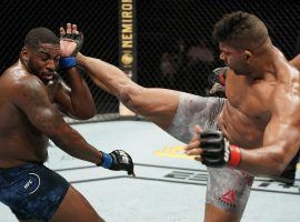 Alistair Overeem (right) kicks Walt Harris (left) during their UFC fight in Jacksonville, Florida on May 16, 2020. (Image: Cooper Neill/Zuffa/Getty)