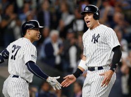 NY Yankees DH Giancarlo Stanton congratulates teammate Aaron Judge after hitting a run in Yankee Stadium in the Bronx. (Image: Jim McIsaac/Getty)
