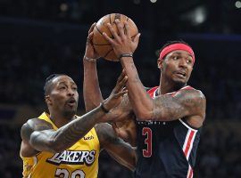 Washington Wizards guard Bradley Beal defended by LA Lakers center Dwight Howard in 2019. (Image: Mark J. Terrill/AP)