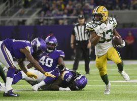 Green Bay packers running back, Aaron Jones, evades the Minnesota Vikings defense during a game at US Bank Stadium in Minneapolis. (Image: Craig Lassig/AP)