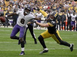 Baltimore Ravens QB Lamar Jackson stiff arms TJ Watt from the Pittsburgh Steelers at Heinz Stadium