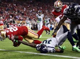 San Francisco 49ers safety Jaquiski Tartt dives over the goal line against the Seattle Seahawks in 2019. (Image: Ezra Shaw/Getty)