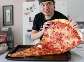 Competitive Eater Matt Stone eats a large slice of pizza for his 11.9 million YouTube subscribers. (Image: YouTube)