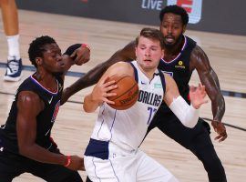 Dallas Mavs All-Star Luka Doncic defended by Reggie Jackson and JaMychal Green from the LA Clippers in Game 1. (Image: Kevin C. Cox/Getty)