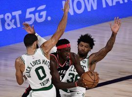 The Boston Celtics swarm Toronto Raptors big man Pascal Siakim. (Image: Douglas P. DeFelice/Getty)