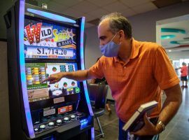 Kentucky Downs Director of Marketing John Wholihan plays one of the facility's HHR machines. One type of machine was ruled illegal in a state Supreme Court ruling. (Image: Grace Ramey/Bowling Green Daily News)