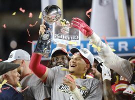 INSERT Kansas City quarterback Patrick Mahomes hoists the 2020 Super Bowl trophy. (Image: Getty)