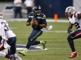 Russell Wilson, Seattle Seahawks quarterback and new MVP favorites, surveys the field against the New England Patriots. (Image: Joe Nicholson/USA Today Sports)