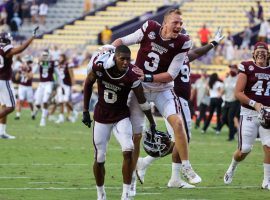 Mississippi State players celebrate their 44-34 upset victory over LSU in the SEC match up in College Football Week 4. (Image: USA Today Sports)
