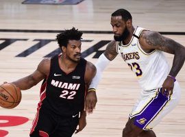 Miami Heat's Jimmy Butler drives by LA Lakers star LeBron James during Butler's triple-double performance in Game 3. (Image: Douglas P. DeFelice/Getty)