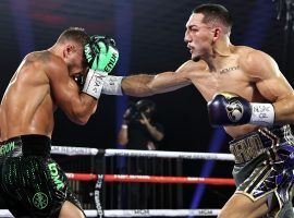 Vasiliy Lomachenko (left) underwent shoulder surgery following his loss to Teofimo Lopez (right). (Image: Mikey Williams/Top Rank/Getty)