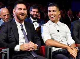 Lionel Messi (left) and Cristiano Ronaldo (center) will meet up in the group stage of the Champions League for the first time this season. (Image: Harold Cunningham/UEFA/Getty)