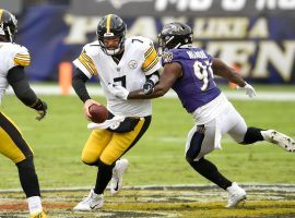 Ben Roethlisberger of the Pittsburgh Steelers evades a tackler in AFC North action. (Image: Nick Wass/AP)