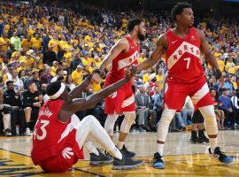 Toronto Raptors guard Kyle Lowry helps teammate Pascal Siakim. (Image: Nathaniel S. Butler/Getty)