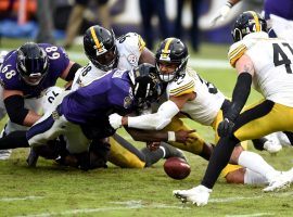 Baltimore Ravens QB Lamar Jackson gets stuffed by Pittsburgh Steelers LB Minkah Fitzpatrick. (Image: Gail Burton/AP)