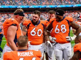 DENVER, CO - SEPTEMBER 15:  Connor McGovern #60 of the Denver Broncos talks to teammates on the offensive line, including Garett Bolles #72, Elijah Wilkinson #68, and Dalton Risner #66 as they sit in the bench area during a game against the Chicago Bears at Empower Field at Mile High on September 15, 2019 in Denver, Colorado. (Photo by Dustin Bradford/Getty Images)