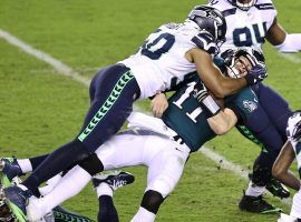 Philadelphia quarterback Carson Wentz was manhandled most of the game against Seattle, but did manage a Hail Mary pass at the end of game that gave one gambler a devastating $500,000 bad beat. (Image: Getty)