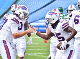 Buffalo Bills QB Josh Allen seen here celebrating a touchdown with teammate Josh Brown against the NY Jets. Allen and the Buffalo Bills secured the #2 seed in the AFC Conference playoffs and +350 odds to win the AFC. (Image: Mark Konezny/USA Today Sports)