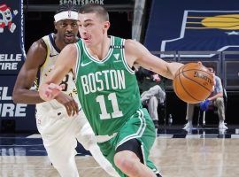 Boston Celtics rookie guard Payton Pritchard, seen here driving by the Indiana Pacers, will miss a couple of weeks with a knee injury. (Image: Ron Hoskins/Getty)