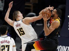 Denver Nuggets center Nikola Jokic, seen here blocking Utah Jazz's Rudy Gobert, helped end the Jazz's 11-game winning streak. The Denver Nuggets and Utah Jazz are embroiled in a tight Northwest division race. (Image: David Zalubowski/AP)