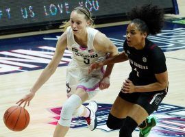UCONN freshman Paige Bueckers, seen here driving by South Carolina's Zia Cooke, scored the last 13 points for UCONN during a victory over the top-ranked team in the country. (Image: David Butler/USA Today Sports)