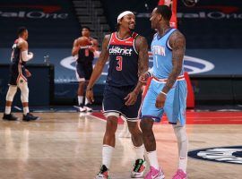 Former teammates, Bradley Beal (left) and John Wall (right) share pleasantries during a Washington Wizards and Houston Rockets game. (Image: Donald Becker/Getty)