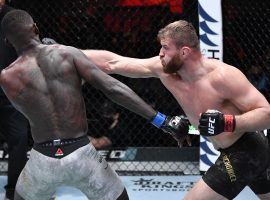 Jan Blachowicz (right) defeated Israel Adesanya (left) to retain his light heavyweight title in the main event of UFC 259. (Image: Jeff Bottari/Zuffa/Getty)