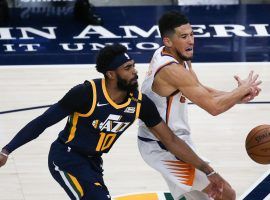 Utah Jazz point guard Mike Conley defense Devin Booker of the Phoenix Suns in Salt Lake City on New Year's Eve. The Jazz and Suns have the top ATS records in the NBA. (Image: Yukai Peng/Getty)