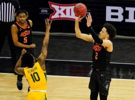 Cade Cunningham of the Oklahoma State Cowboys shoots a 3-pointer over Baylor's Adam Flagler in the Big 12 tournament semifinals at T-Mobile Center in Kansas City, MO. (Image: Jay Biggerstaff/USA Today Sports)